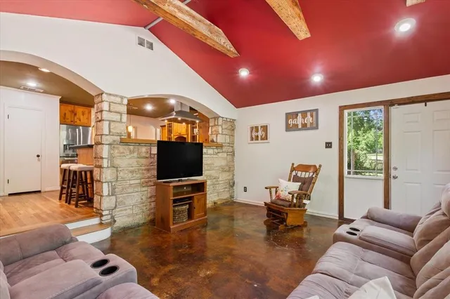 a living room with furniture and a flat screen tv