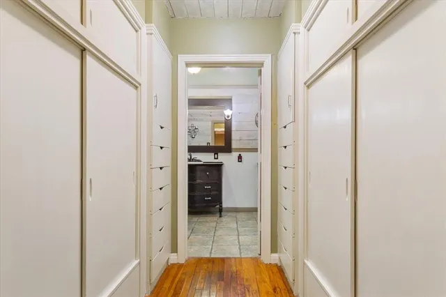 a view of a hallway with wooden floor and staircase
