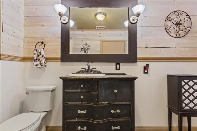 a bathroom with a sink vanity and a mirror