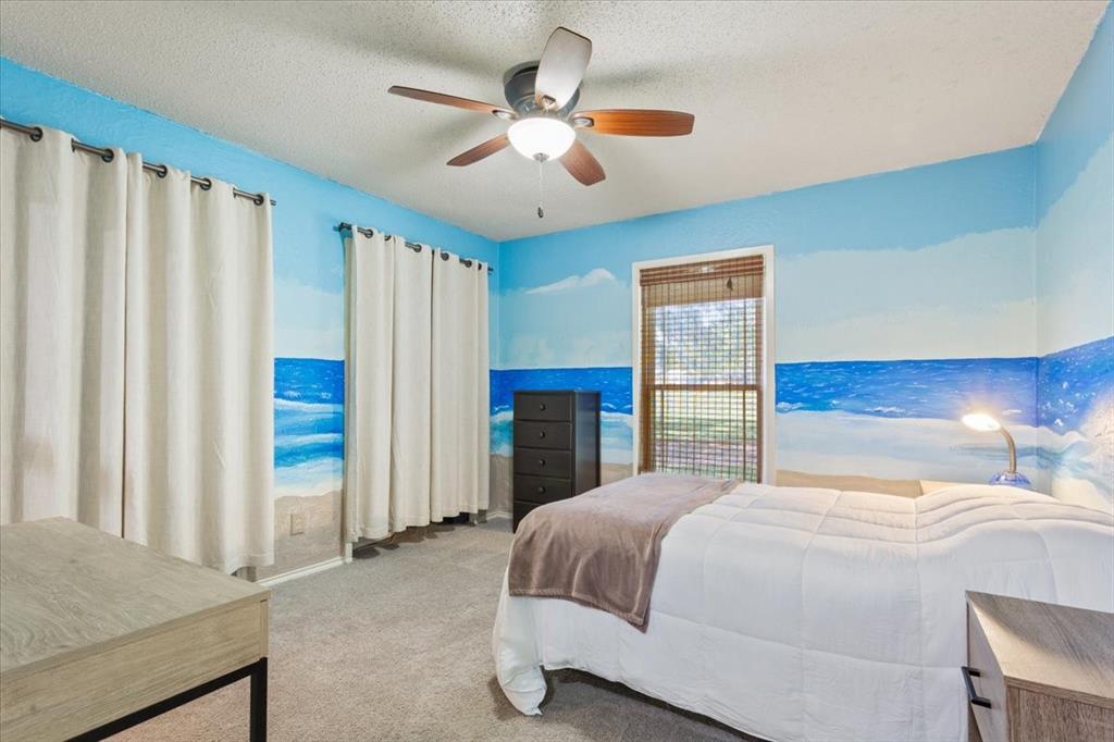 3015 Sturgis Lane Waco, TX 76708 - Photo 24 of 40 a bedroom with a large bed and a chandelier