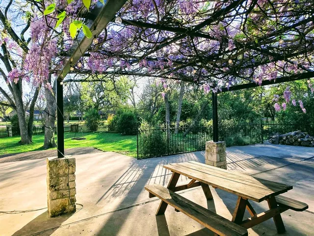 a view of a patio with a table chairs and a fire pit