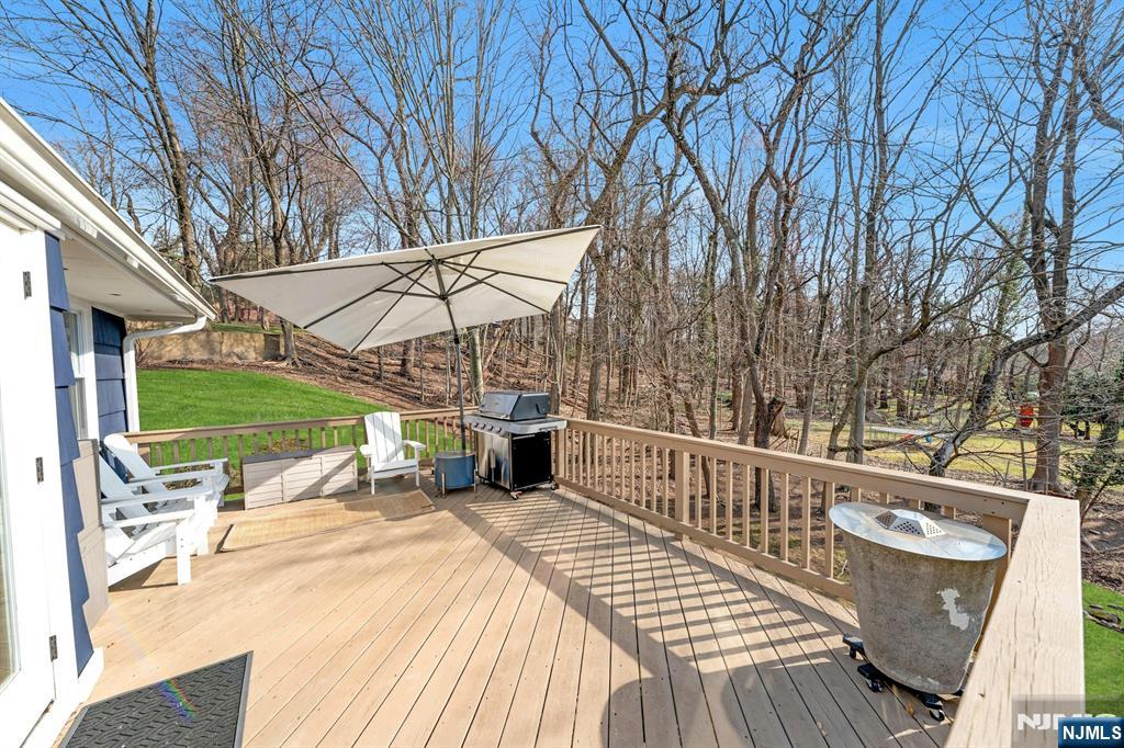 108 Hendrickson Street Haworth, NJ 07641 - Photo 29 of 38 a view of a roof deck with wooden floor and fence