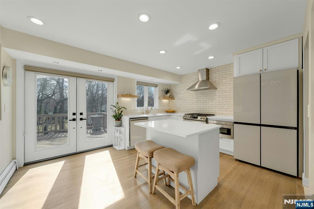 108 Hendrickson Street Haworth, NJ 07641 - Photo 4 of 38 a kitchen with white cabinets and refrigerator