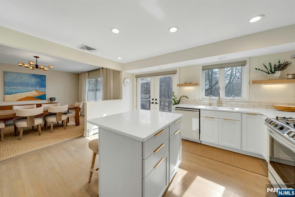 108 Hendrickson Street Haworth, NJ 07641 - Photo 7 of 38 a kitchen with a sink stove and cabinets