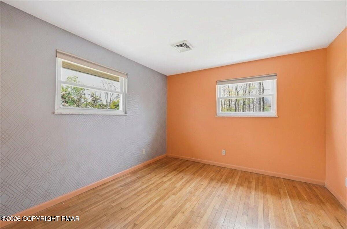 345 Laurel Lake Road Bartonsville, PA 18321 - Photo 27 of 82 a view of an empty room with wooden floor and a window