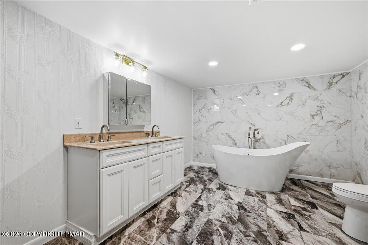 345 Laurel Lake Road Bartonsville, PA 18321 - Photo 46 of 82 a bathroom with a sink and mirror with toilet