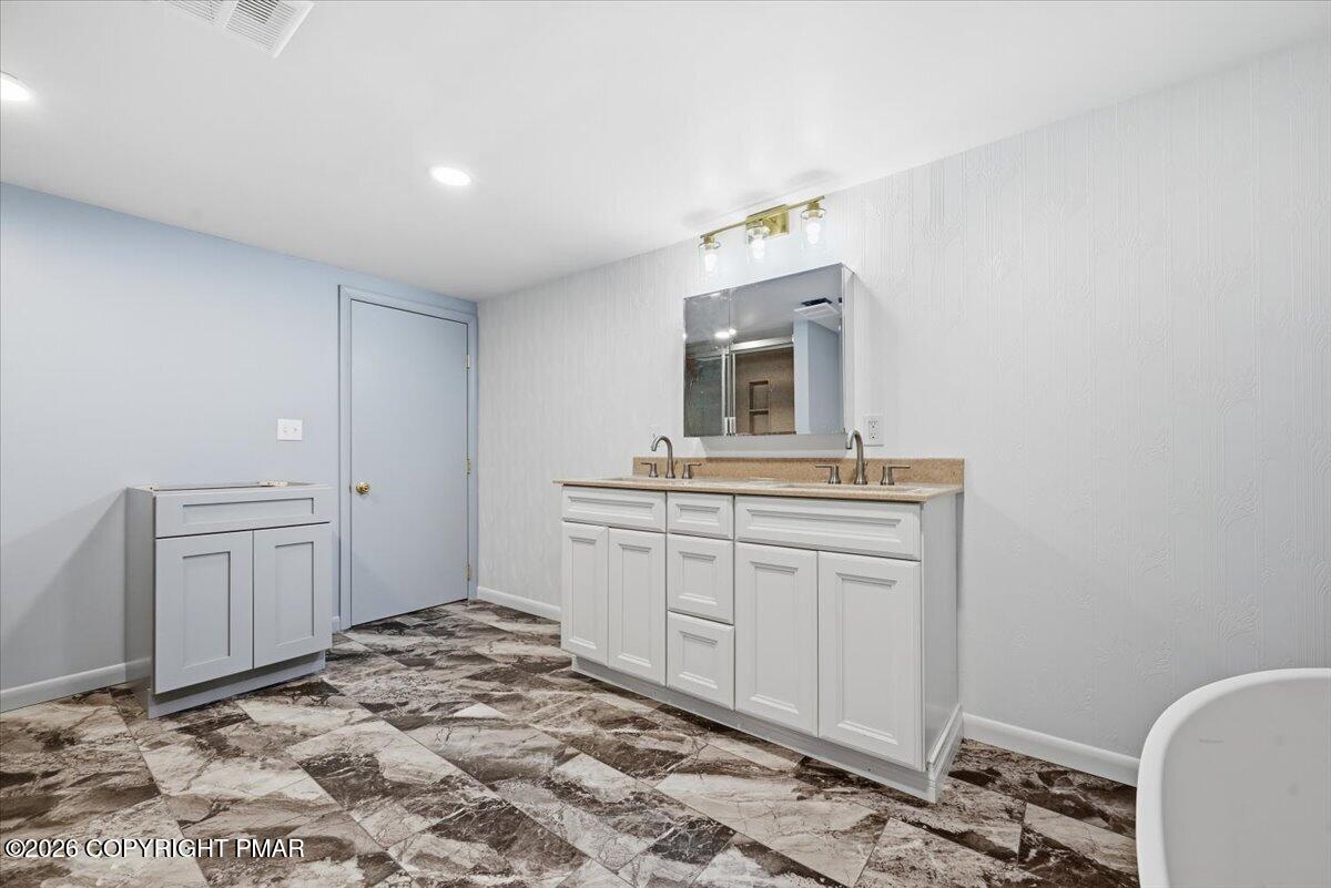 345 Laurel Lake Road Bartonsville, PA 18321 - Photo 48 of 82 a spacious bathroom with a granite countertop sink and a mirror