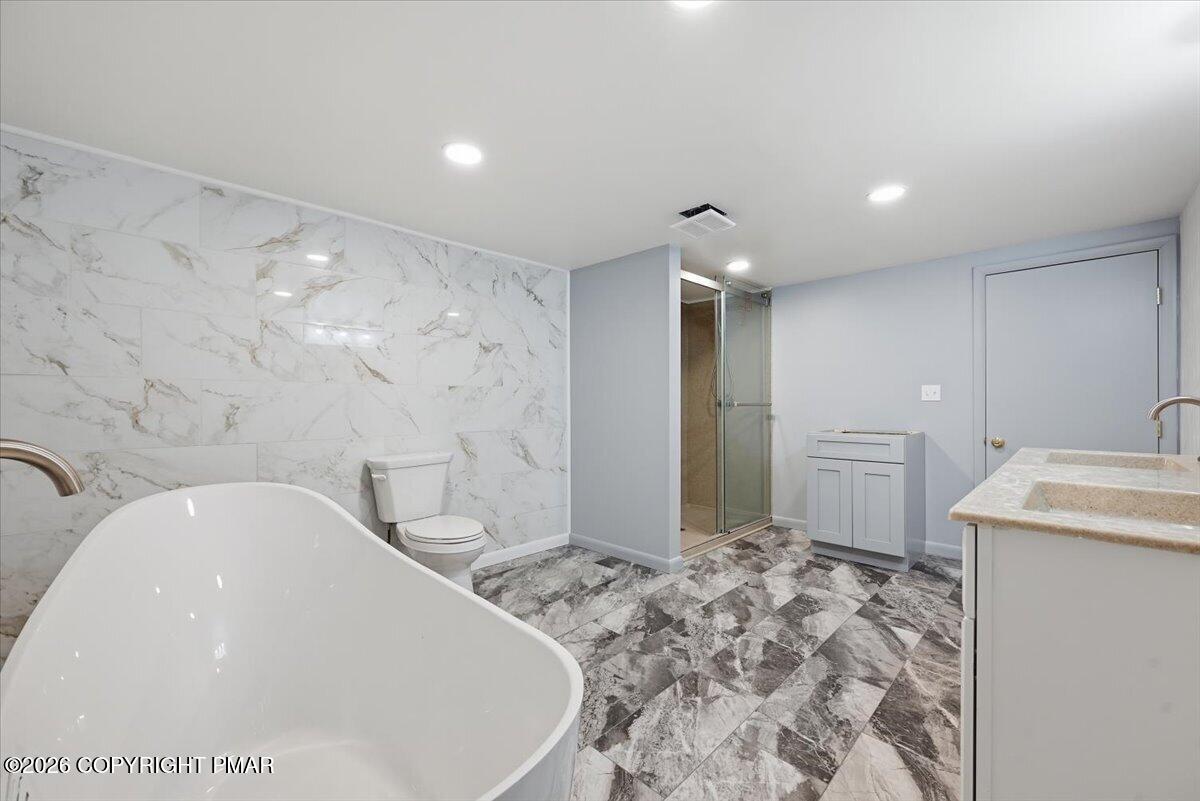 345 Laurel Lake Road Bartonsville, PA 18321 - Photo 49 of 82 a spacious bathroom with a sink a toilet and a mirror
