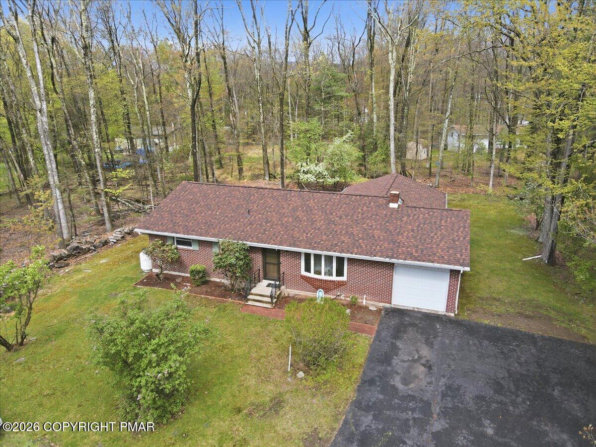 345 Laurel Lake Road Bartonsville, PA 18321 - Photo 66 of 82 a aerial view of a house with a yard table and chairs