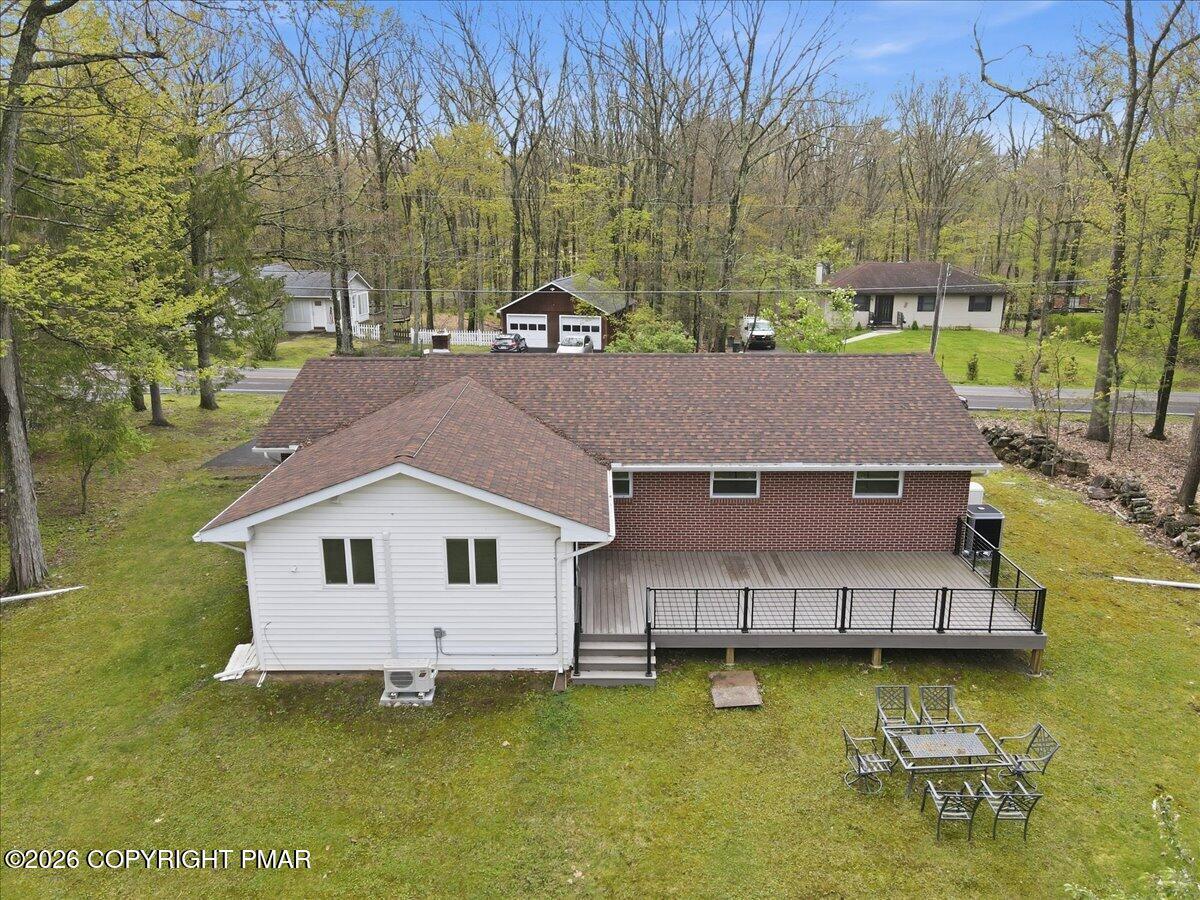 345 Laurel Lake Road Bartonsville, PA 18321 - Photo 71 of 82 a aerial view of a house with swimming pool next to a yard