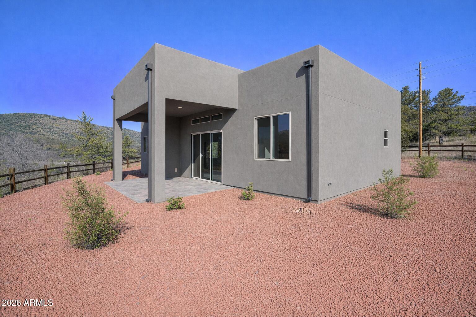 125 Starlight Way Sedona, AZ 86351 - Photo 11 of 11 a view of a white house with a large space in front of it