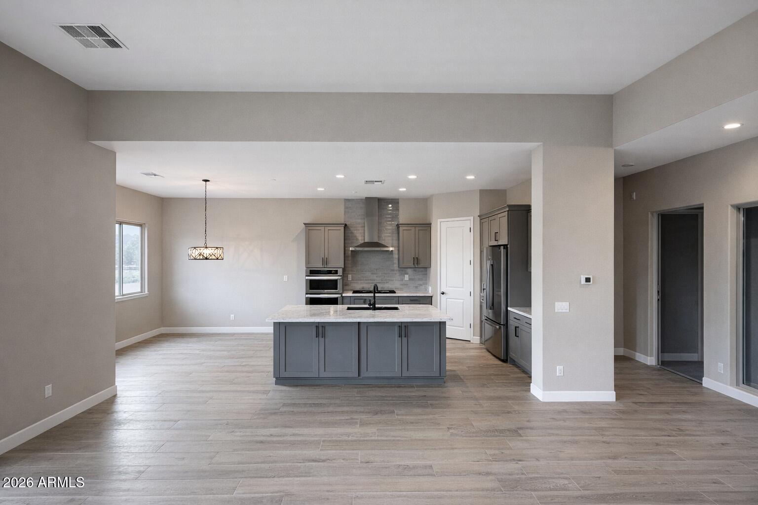 125 Starlight Way Sedona, AZ 86351 - Photo 5 of 11 a large kitchen with stainless steel appliances granite countertop a stove and a refrigerator