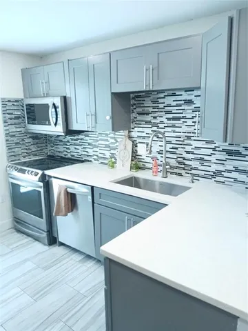 a kitchen with kitchen island granite countertop wooden cabinets and white appliances
