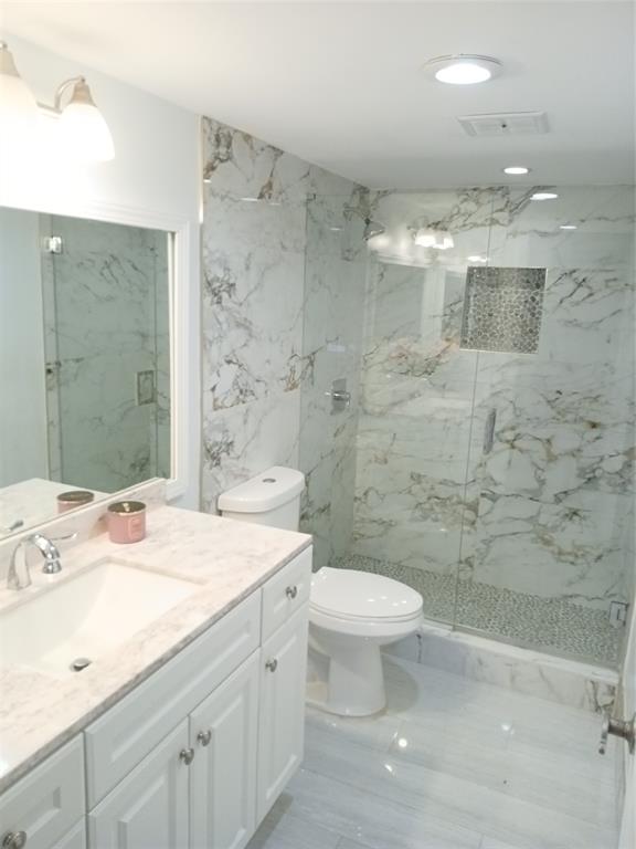 4170 Inverrary Drive, Unit 412 Lauderhill, FL 33319 - Photo 9 of 15 a bathroom with a sink a toilet and shower