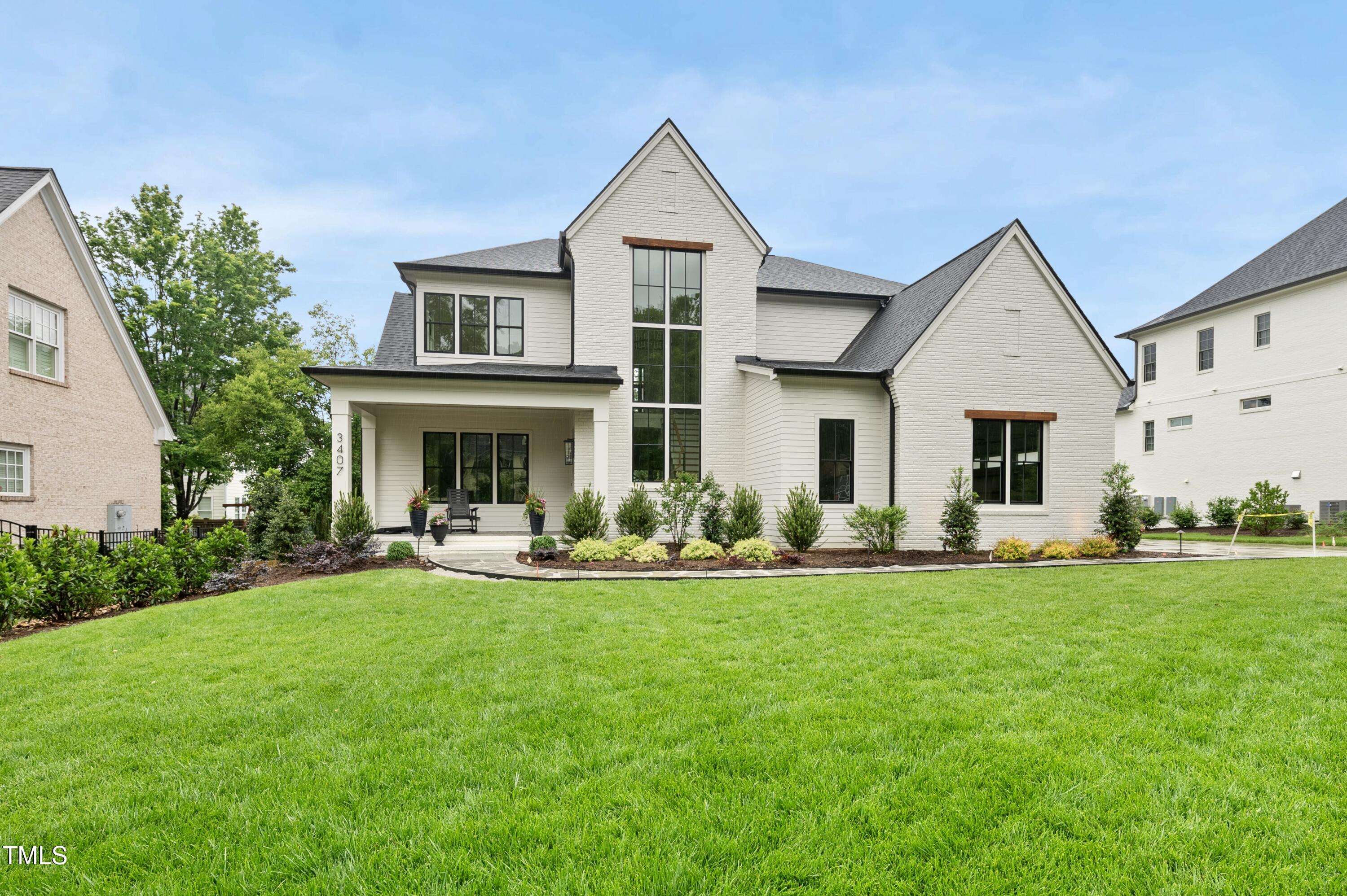 a front view of a house with a garden and porch