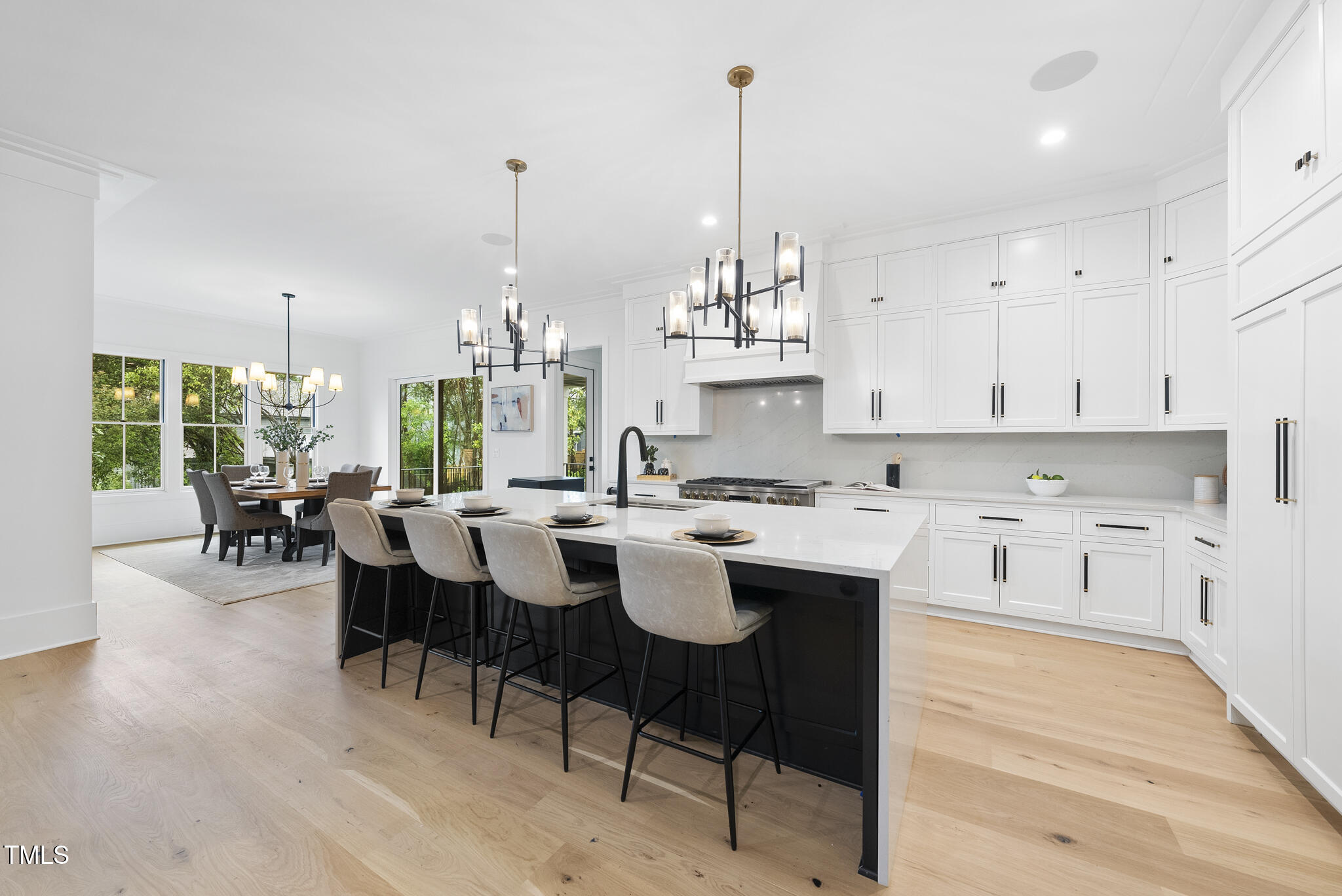 3407 Churchill Road Raleigh, NC 27607 - Photo 2 of 44 a open kitchen with stainless steel appliances granite countertop a sink dishwasher a stove a dining table with chairs with wooden floor