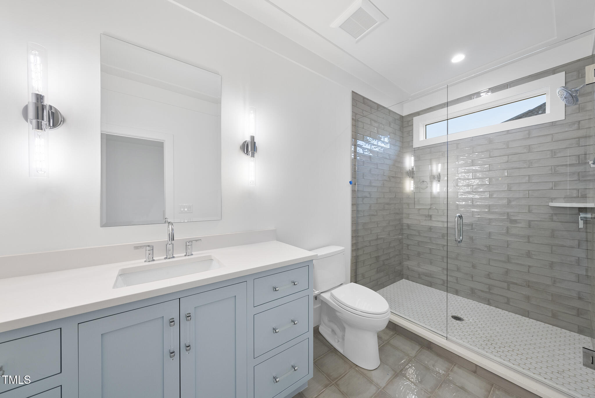 3407 Churchill Road Raleigh, NC 27607 - Photo 29 of 44 a bathroom with a double vanity sink toilet and shower