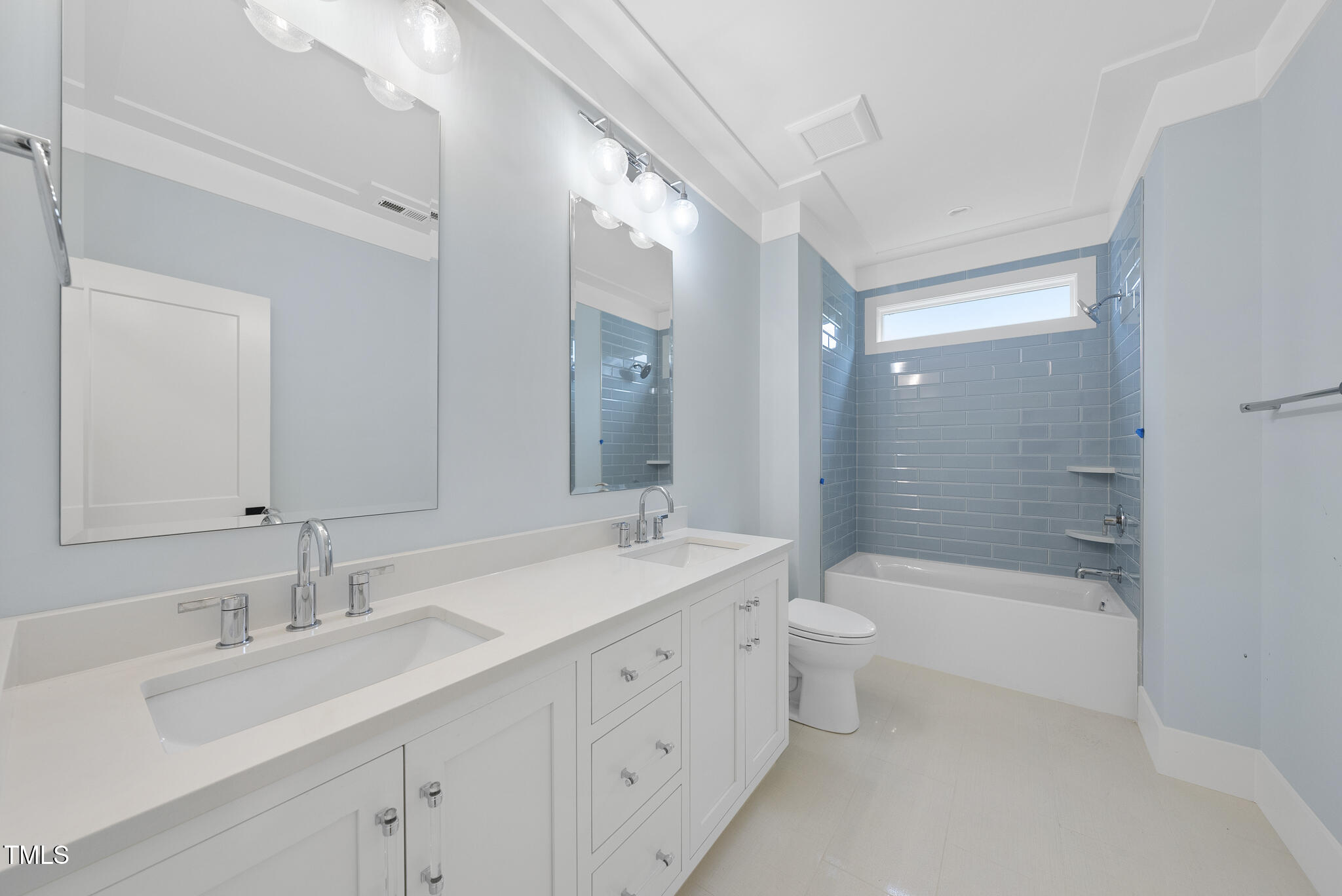3407 Churchill Road Raleigh, NC 27607 - Photo 31 of 44 a bathroom with a double vanity sink toilet mirror and bathtub