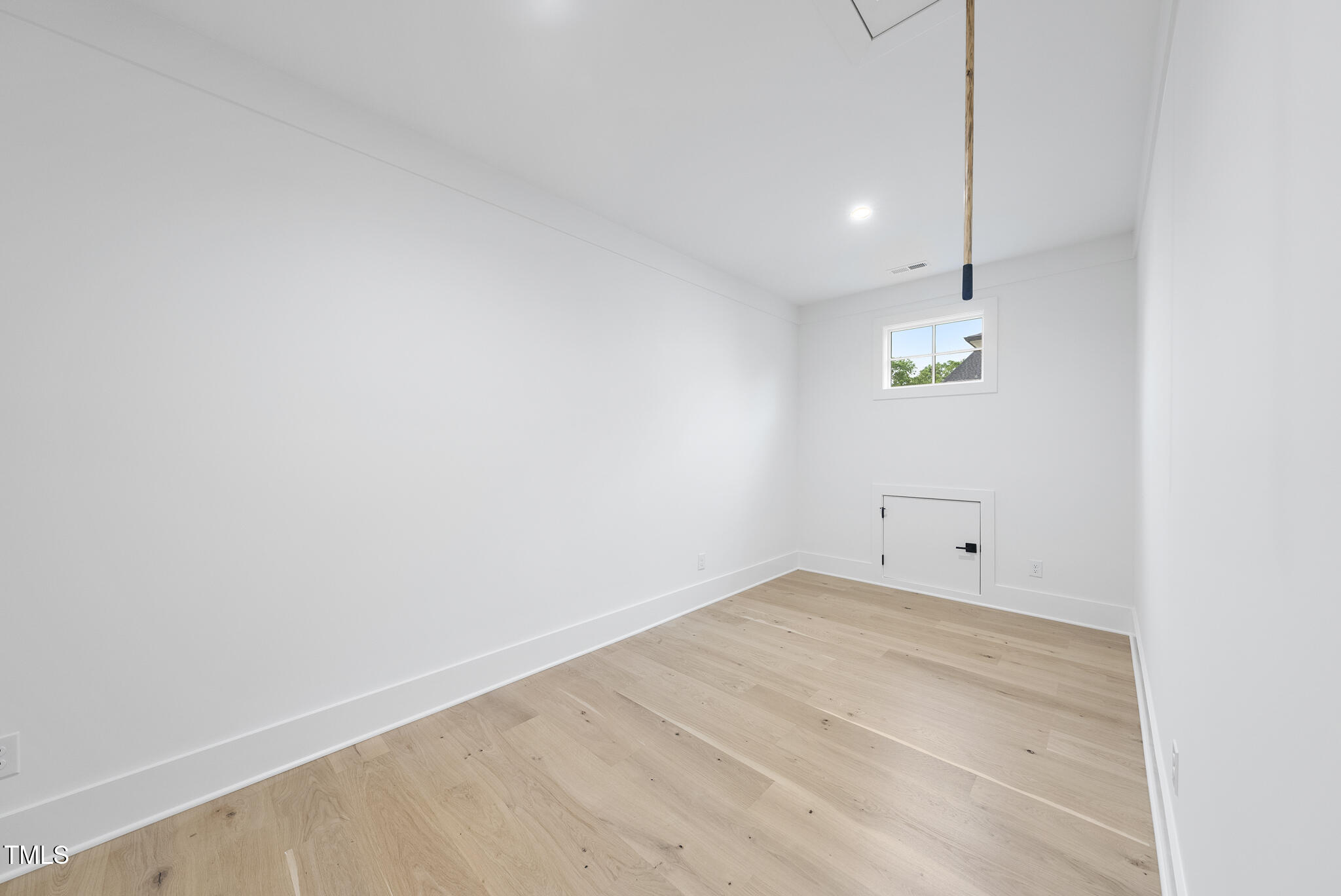 3407 Churchill Road Raleigh, NC 27607 - Photo 32 of 44 a view of empty room with wooden floor and window