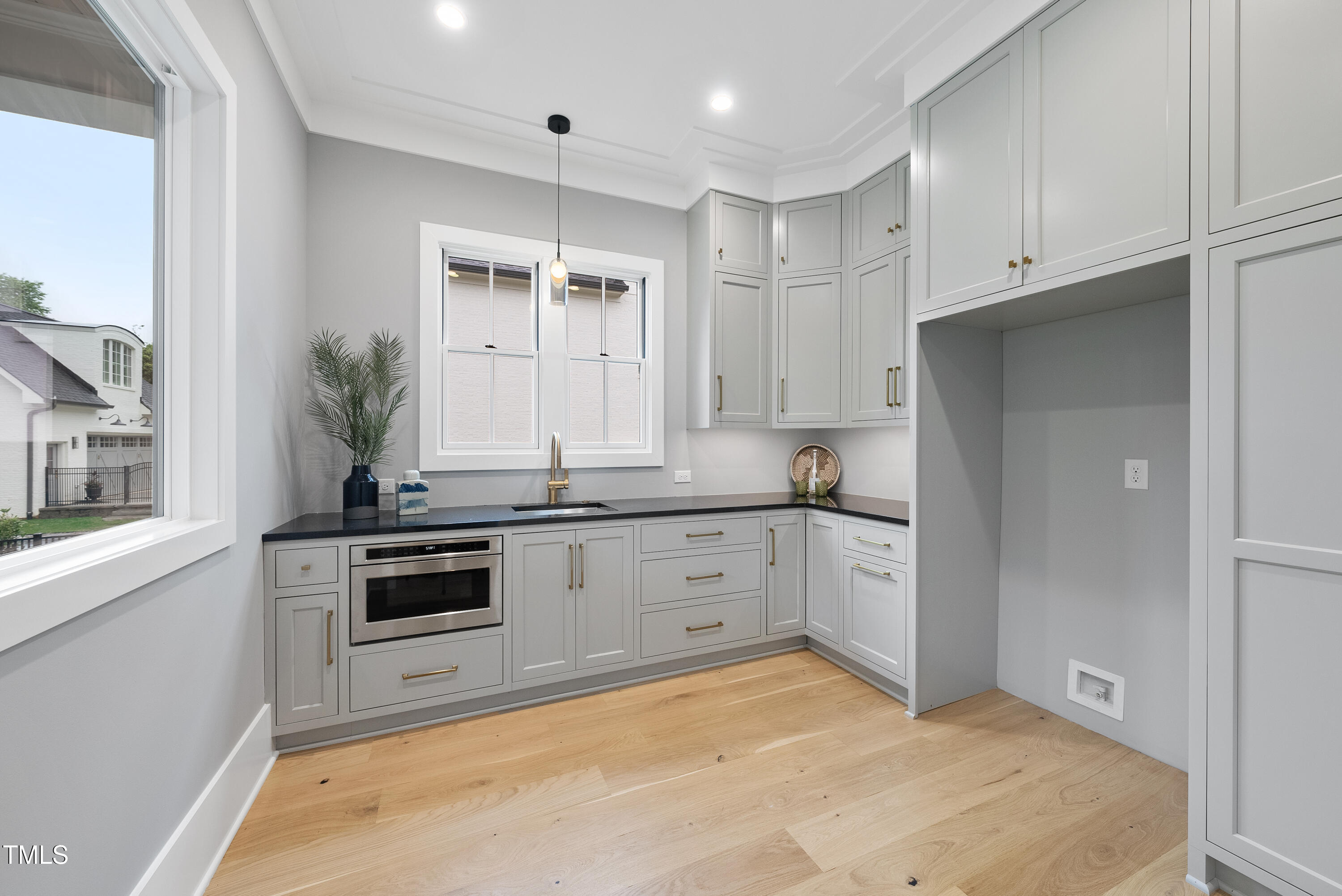 3407 Churchill Road Raleigh, NC 27607 - Photo 6 of 44 a large white kitchen with stainless steel appliances granite countertop a stove and a sink