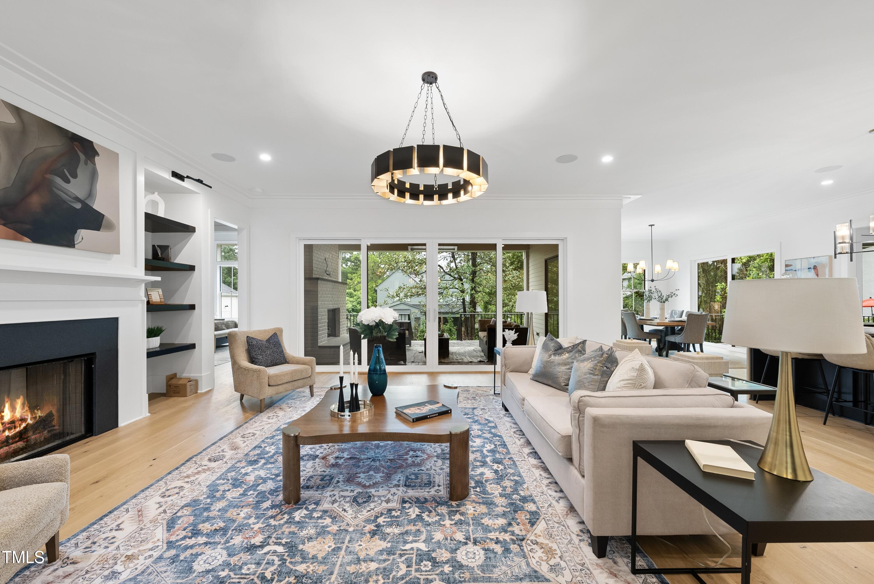 3407 Churchill Road Raleigh, NC 27607 - Photo 10 of 44 a living room with furniture a window and a fireplace