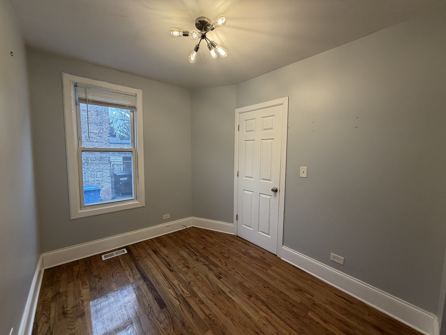 3614 West George Street, Unit 2R Chicago, IL 60618 - Photo 8 of 12 a view of empty room with wooden floor and fan