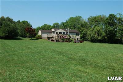 6347 Durham Road Riegelsville, PA 18077 - Photo 1 of 10 a view of a house with backyard garden and trees