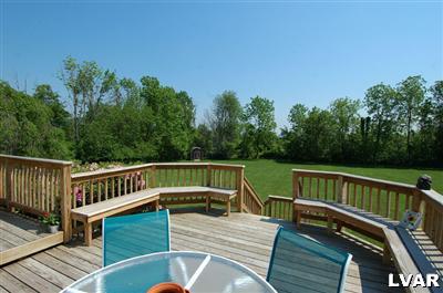 6347 Durham Road Riegelsville, PA 18077 - Photo 4 of 10 a view of a roof deck with couches chairs and wooden floor