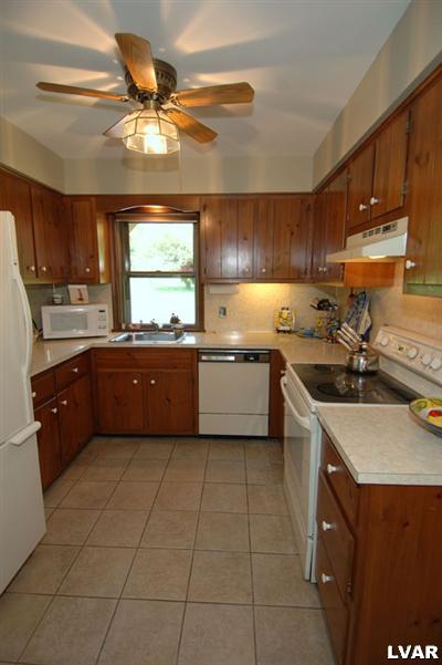 6347 Durham Road Riegelsville, PA 18077 - Photo 6 of 10 a kitchen with a sink a stove cabinets and a dining table