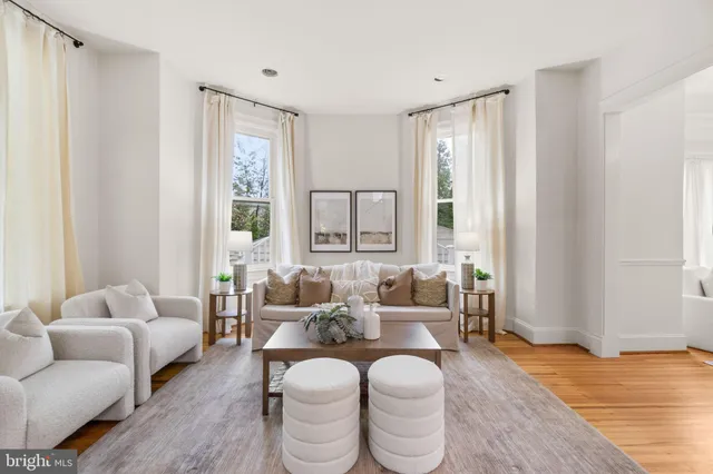 a living room with fireplace furniture and a wooden floor
