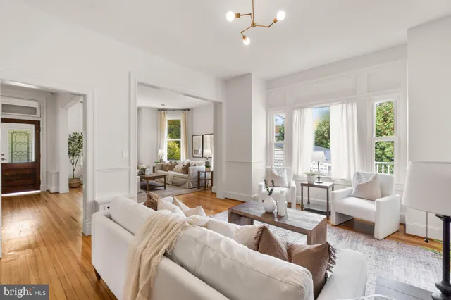 a kitchen with stainless steel appliances a refrigerator a sink dishwasher with a dining table and chairs