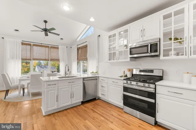 a kitchen with stainless steel appliances a refrigerator and a stove top oven