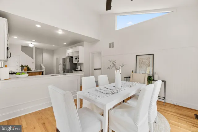 a spacious bedroom with two beds and a chandelier