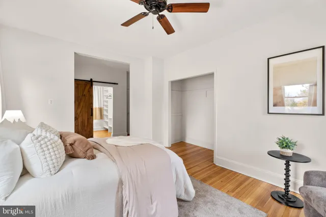 a spacious bedroom with a bed and a chandelier