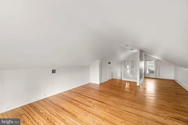 a view of a patio with table and chairs potted plants and large tree