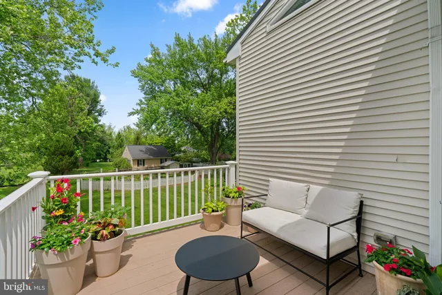 a view of a house with backyard sitting area and garden