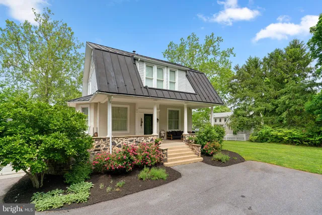 a front view of a house with swimming pool having outdoor seating