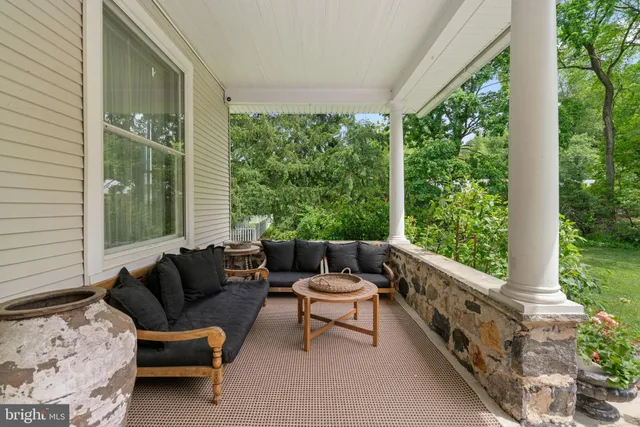 a view of a patio with table and chairs potted plants with wooden floor and fence
