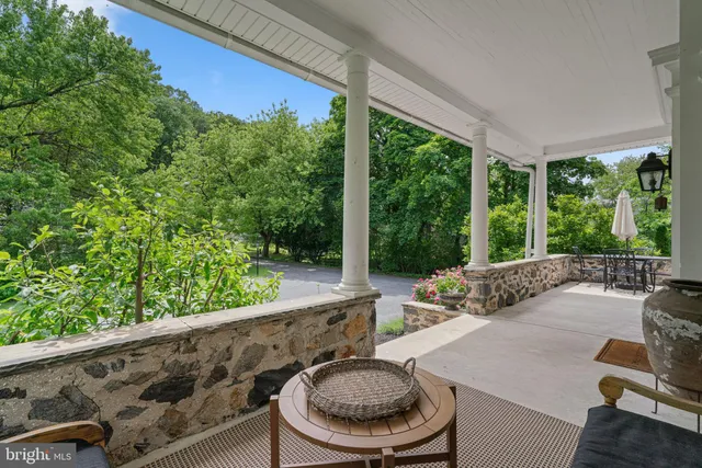 a view of a livingroom with wooden floor and a fireplace