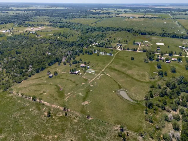 an aerial view of a houses with a yard