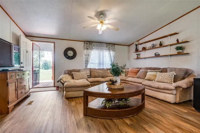 a living room with furniture and wooden floor