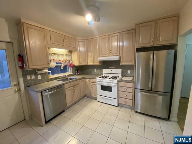 a kitchen with cabinets and stainless steel appliances