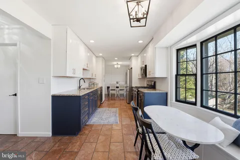 a view of a workspace with a window and chair