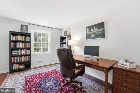 a bedroom with a bed and painting on the wall