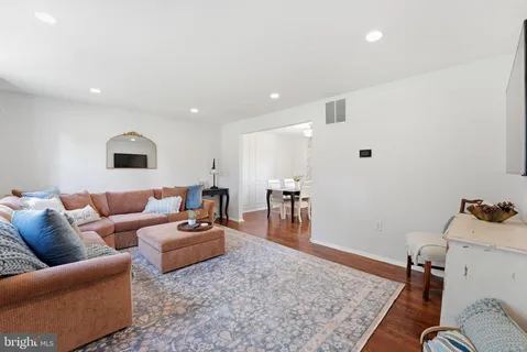 a kitchen with stainless steel appliances granite countertop a refrigerator a sink a stove and white cabinets