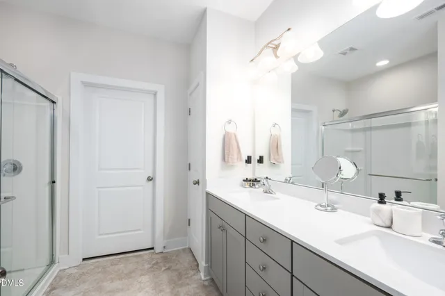 a bathroom with double sink and a mirror