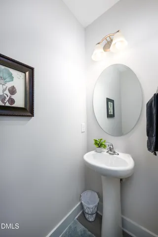 a bathroom with a sink toilet and mirror