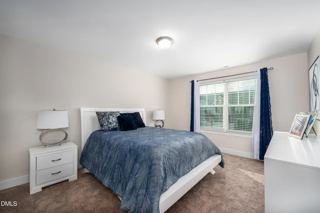 a bedroom with a bed and large window