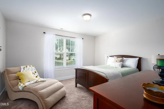 a bedroom with two beds and a window