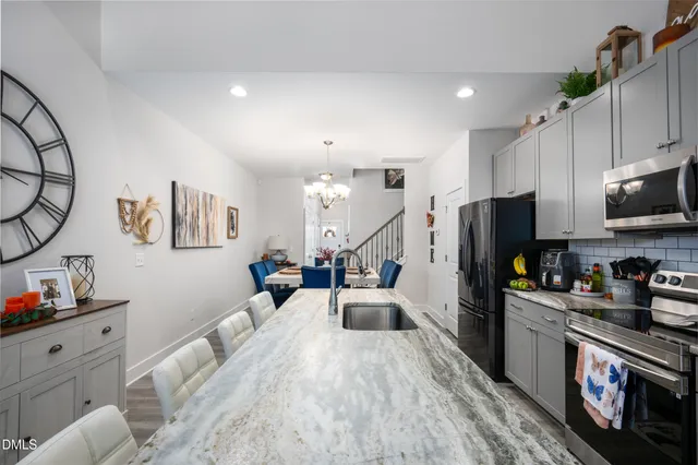 a large white kitchen with stainless steel appliances